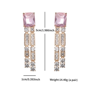 Detailed view of rose gold drop earrings with pink square stones and size dimensions