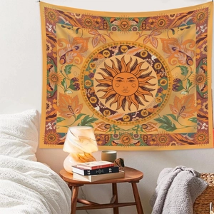Detail of yellow Bohemian sun and zodiac tapestry hanging above a cozy wooden table