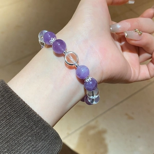 Close-up of natural amethyst beaded bracelet with silver spacers on woman's wrist