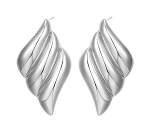 Macro detail of polished silver wing-shaped stud earrings with ribbed texture design