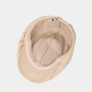 Vintage beige cotton newsboy cap with distressed details and adjustable buckle closure