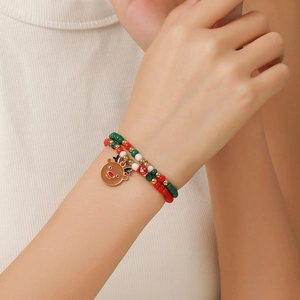 Close-up of Christmas beaded bracelet with reindeer charm on model wrist