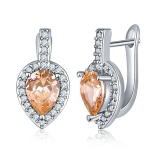 Close-up of champagne pear-cut zirconia halo earrings with silver drop hooks