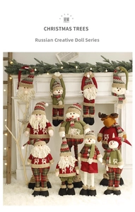 Christmas plush figures displayed on mantelpiece with festive warm lighting and decorations