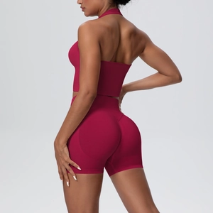 Detail view of burgundy yoga set featuring halter neck top and lifting shorts