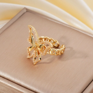 Golden butterfly ring with micro-set crystals and chain band on beige silk