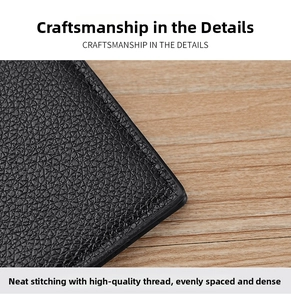 Macro shot of black litchi grain leather wallet with neat stitching and smooth edges