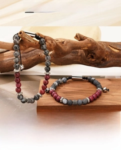 Detail of beaded bracelets with tiger eye stones and magnetic clasp on wooden branches