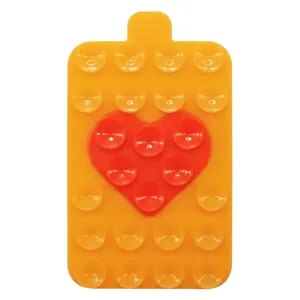 Close-up of heart-shaped silicone suction cup holder with dual-color orange and red texture