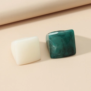 Minimalist resin square rings set in cream white and dark green marble finish