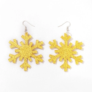 Close-up of gold glitter snowflake earrings with classic hook design for women