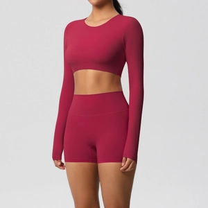 Detail view of deep carmine red yoga set featuring crop top and high-waist shorts texture