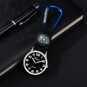 Detail view of quartz pocket watch with compass and blue carabiner on black leather