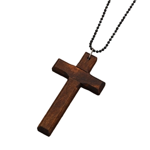 Macro detail of retro wooden cross pendant with visible natural grain and black bead chain