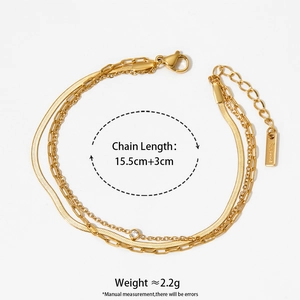 Gold multilayer stainless steel bracelet with snake chain and zircon detail on white background