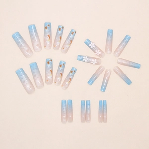 Detail of blue pink gradient coffin nails with koi fish patterns and 3D floral accents