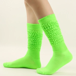 Detail view of neon green slouch socks featuring a ribbed texture and elastic knit design