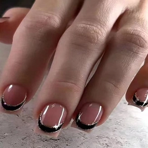 Macro detail of French square press-on nails with nude pink base and black glitter tips