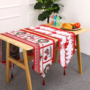 Christmas table runner with Santa and reindeer prints, red tassels, festive home decor
