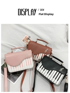 Detailed view of musical piano print crossbody bags in pink, brown and black colors
