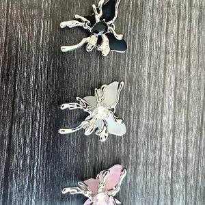 Chic butterfly necklaces in black, white, and pink with liquid metal silver frames