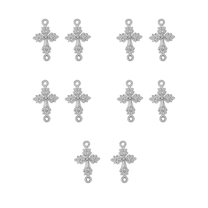 Close-up of 10 silver vintage cross pendants with detailed engraving for DIY jewelry making