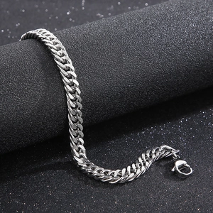 Detailed view of polished silver Cuban link bracelet with a secure lobster clasp mechanism