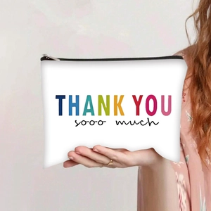 Woman holding canvas makeup bag with Thank You printing and black zipper closure