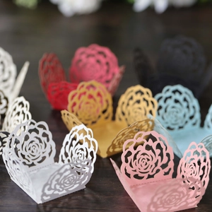 Macro view of laser-cut hollow rose patterns on multi-colored decorative favor boxes
