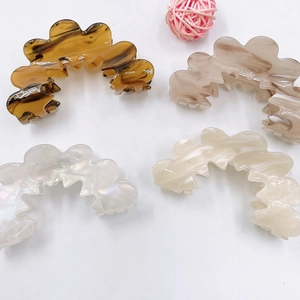 Minimalist acrylic claw hair clips with wave design in amber, marble and pearl finishes