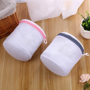 Detail of cylindrical laundry bags with reinforced mesh and protective zipper covers