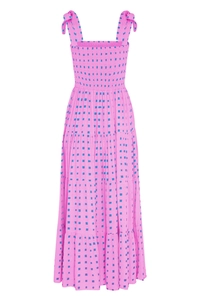 Detail of pink tiered maxi dress featuring smocked bust and blue geometric print