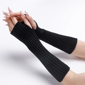 Detail of black ribbed knit arm warmers with fingerless design and textured finish