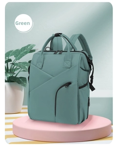 Detailed view of the green multifunctional diaper bag with large capacity storage
