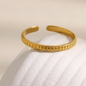Minimalist 18K gold plated beaded open cuff ring displayed on a decorative stone
