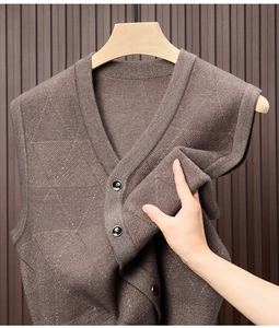 Detail of brown V-neck knitted vest showing textured diamond pattern and soft fabric
