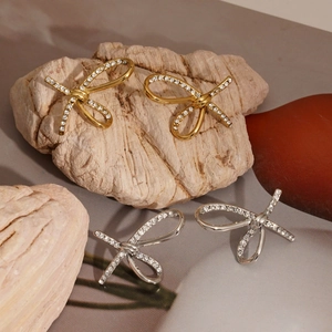 Elegant bow-shaped 316 stainless steel earrings with sparkling cubic zirconia in gold and silver
