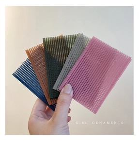 Detail showing five colorful velcro hair pads for bangs styling and fixing loose hair strands