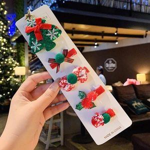 Close-up of a 5-piece Christmas hair clip set with sequins and plaid bow on card