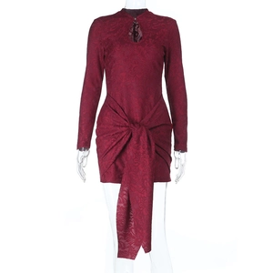 Dettaglio dell'abito mini in pizzo bordeaux con nodo intrecciato e scollatura a goccia