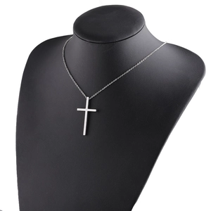Polished silver stainless steel cross pendant on a black mannequin neck display