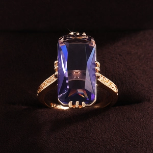 Elegant gold ring featuring a large rectangular gradient purple zircon and carved band
