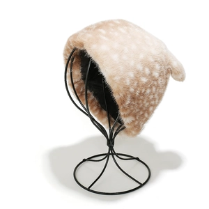 Macro shot of faux fur winter hat texture with reindeer pattern and plush animal ears