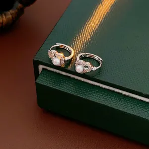 Sparkling zircon hollow heart earrings with white pearls and silver plating for women