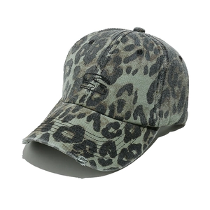 Detailed view of leopard print baseball cap with vintage distressed ripped edge design