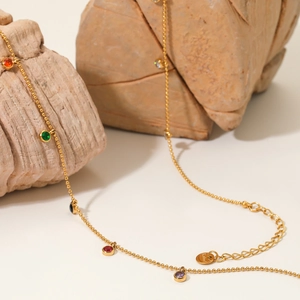 Gold stainless steel necklace with multi-colored cubic zirconia charms on stone props