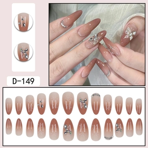 Short almond press-on nails with pink gradient, 3D diamond butterflies, and silver lines