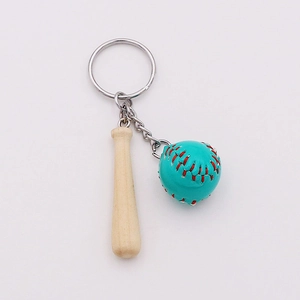 Macro shot of mini wooden baseball bat and blue leather ball with red stitching detail