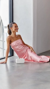 Dettaglio del vestito lungo in raso rosa con schiena scoperta e scollatura a fascia