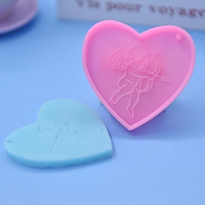 Detail of heart silicone mold featuring Cupid relief and convenient hanging hole design